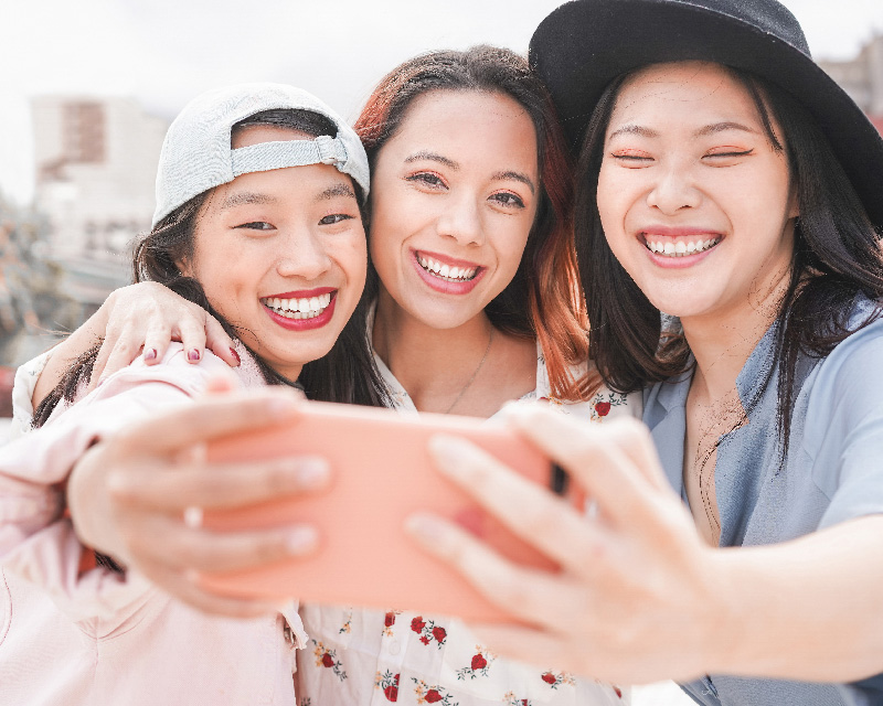 Young Asian women taking a selfie; Therapy for immigrants and multicultural individuals